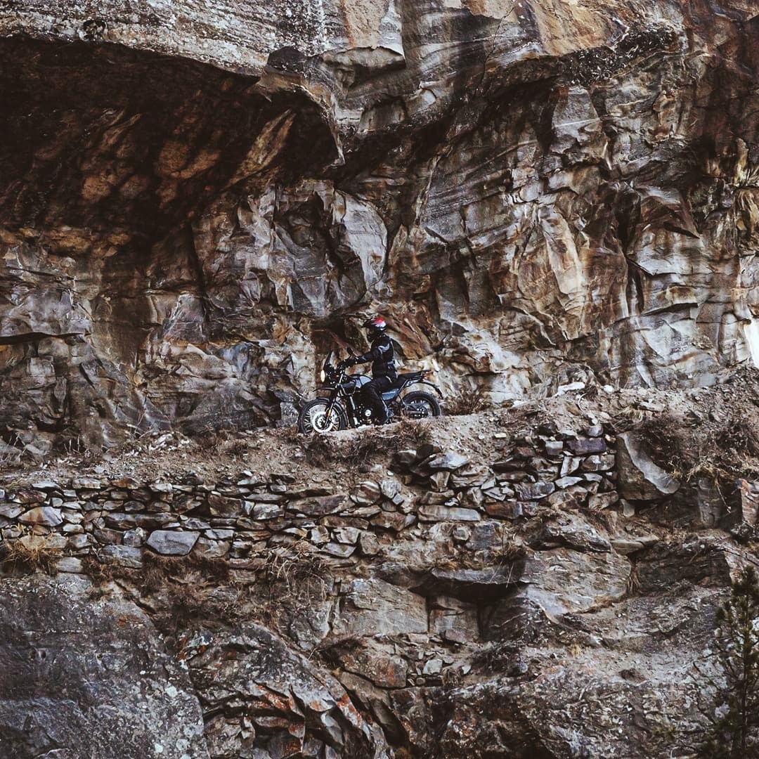 Man on Royal Enfield bike in the Himalaya