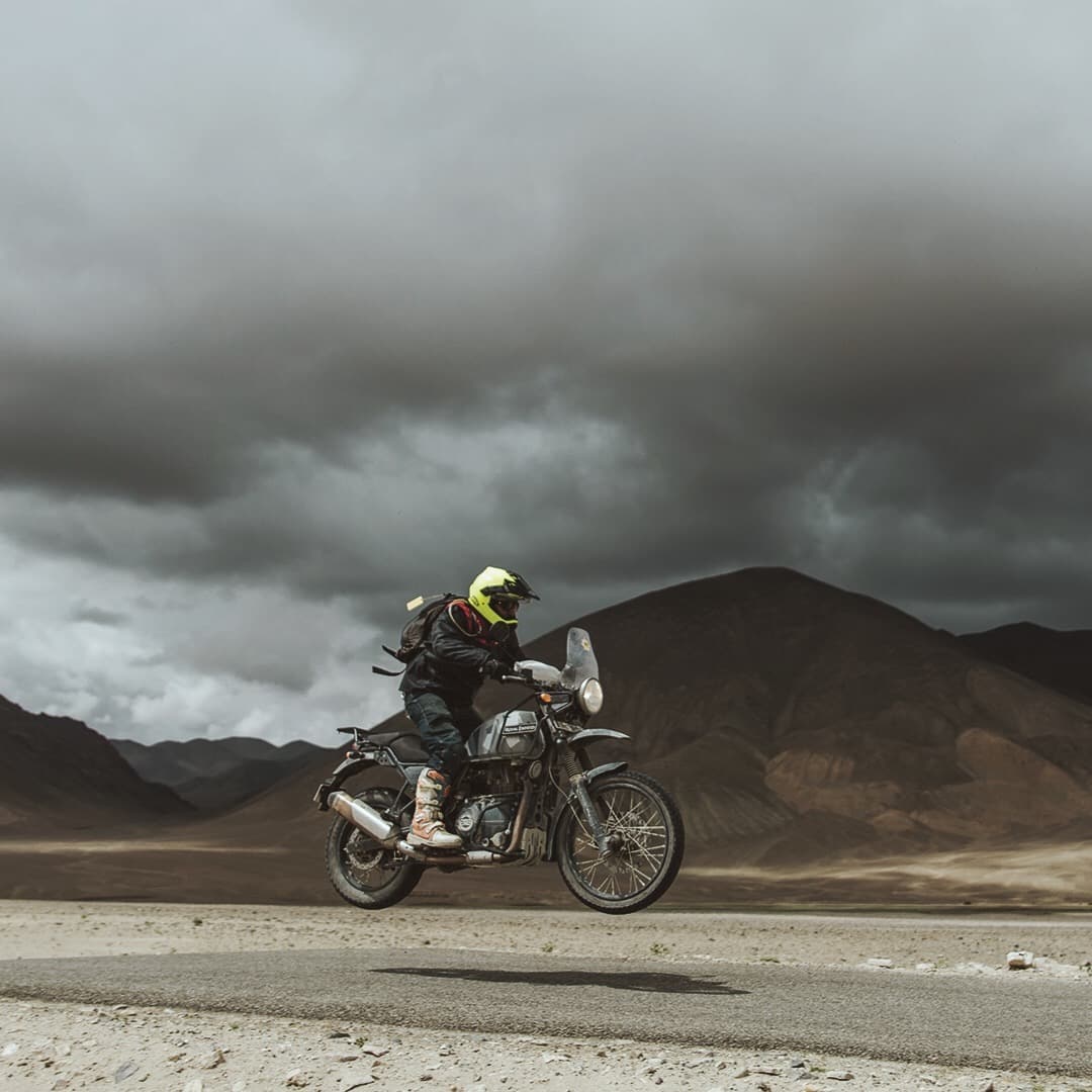 Man on Royal Enfield bike in the Himalaya