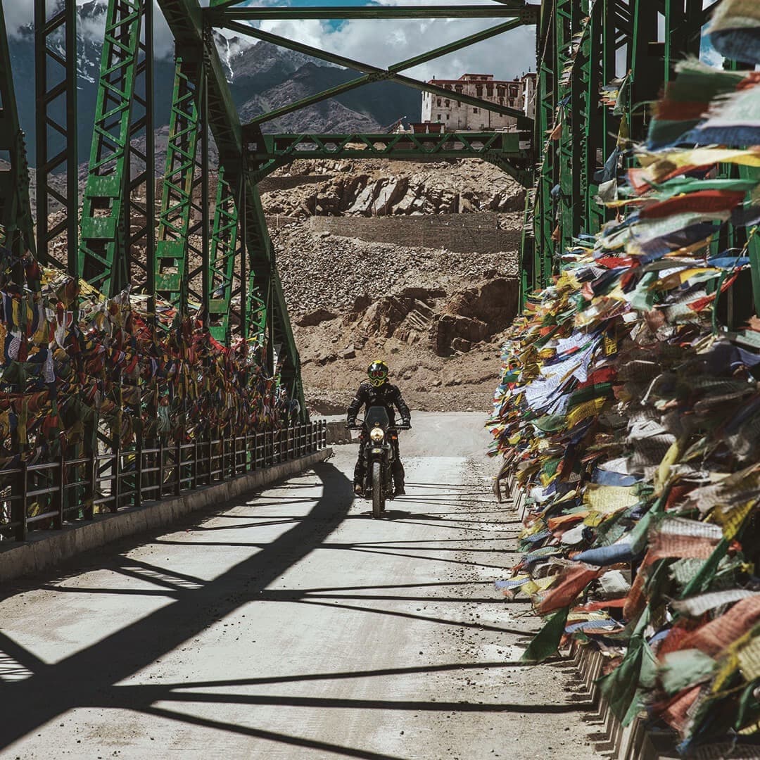 Man on Royal Enfield bike in the Himalaya