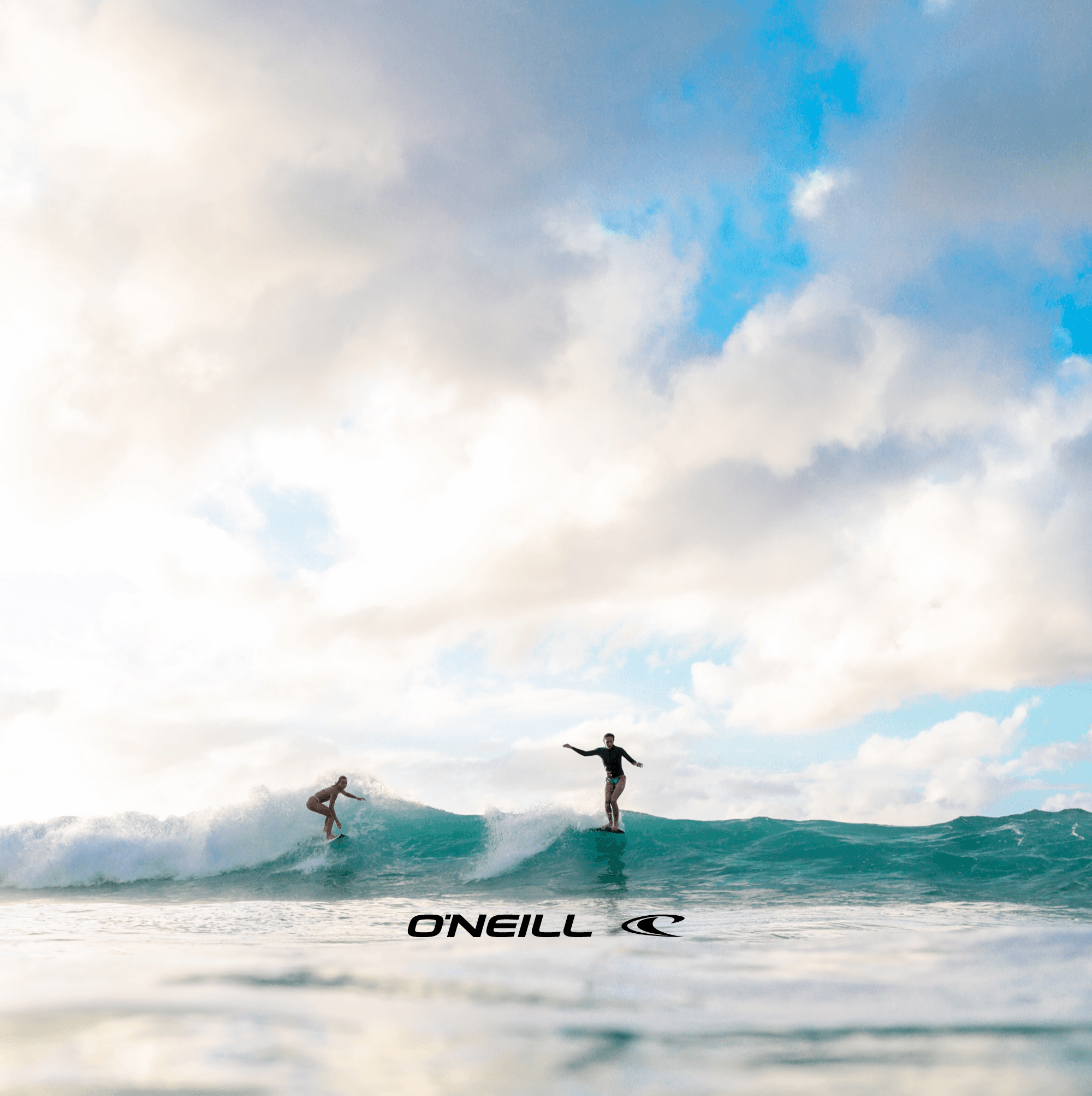girls surfing together a wave