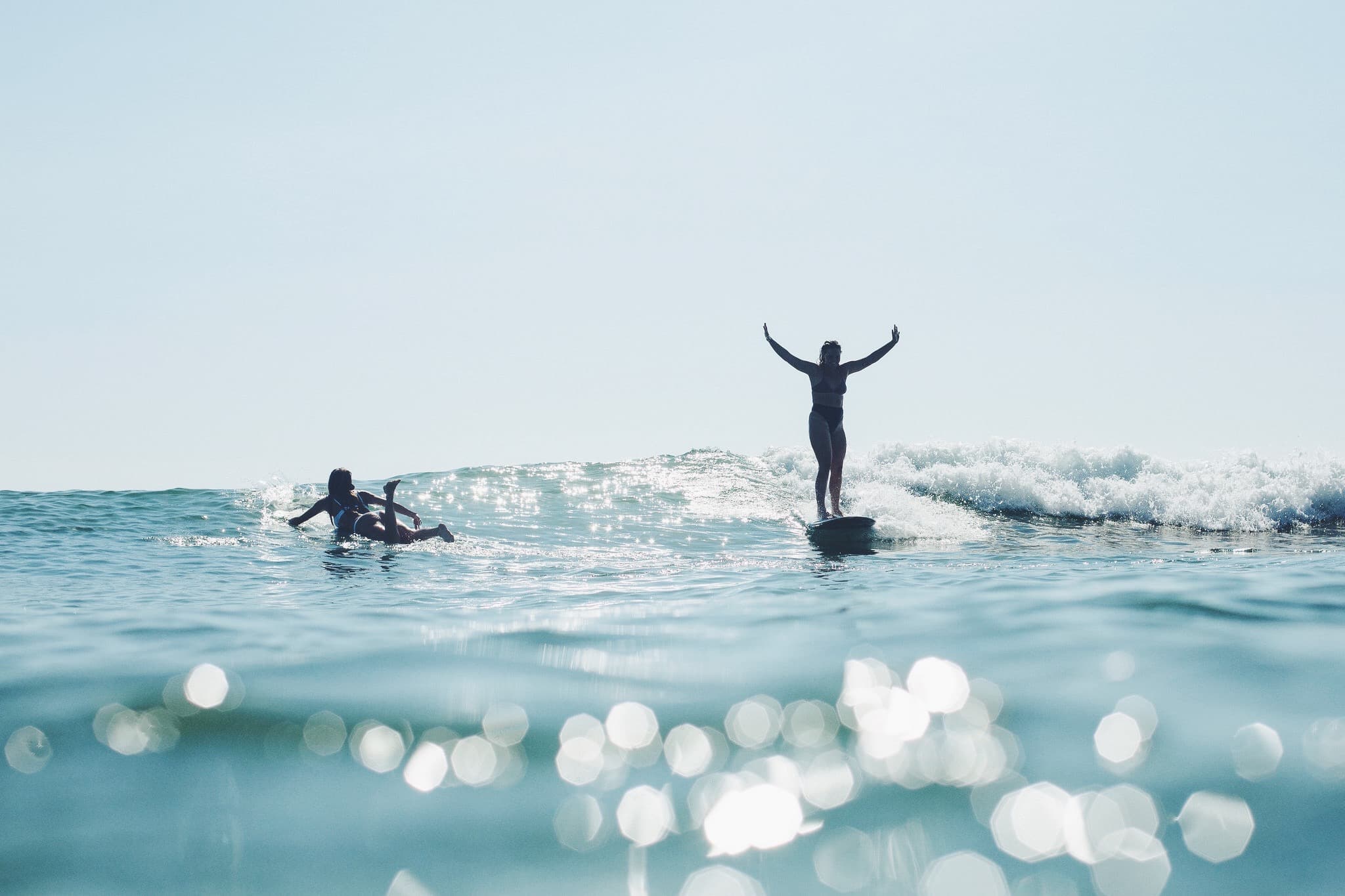 Girl surfing longboard waves in the Maldives