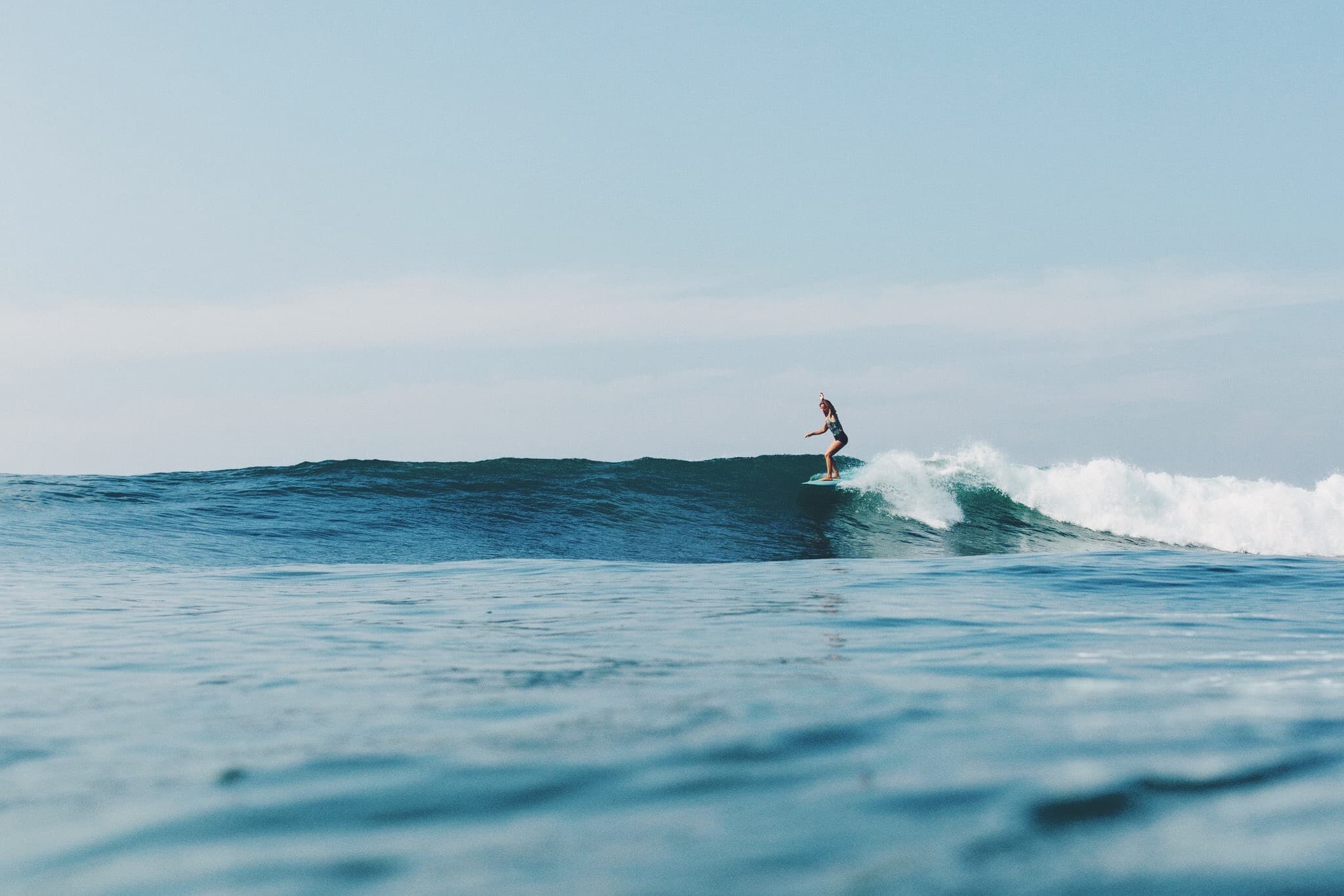 Girls surfing in the Maldives on a Land of Ride trip