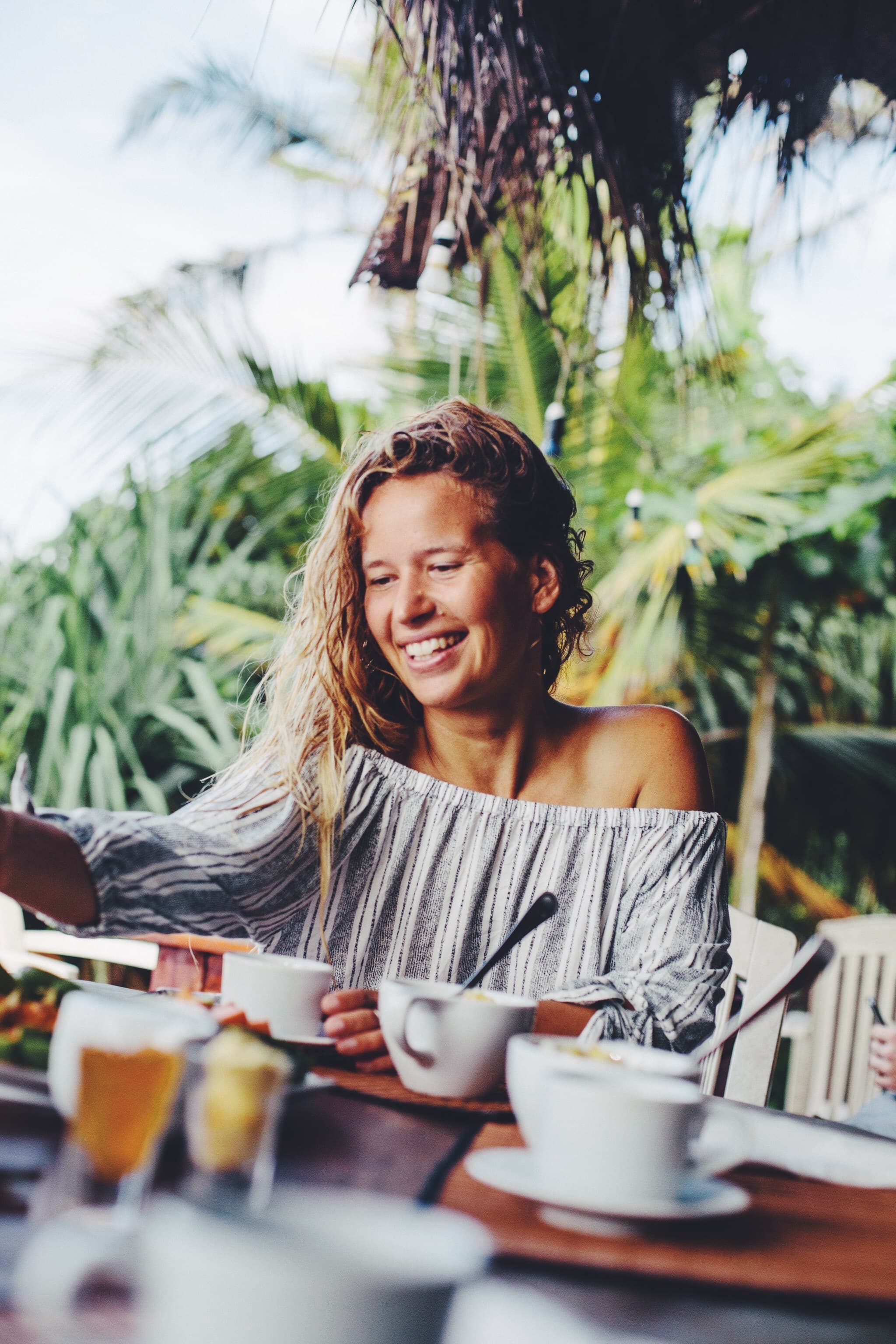 Girl having breakfast a a tropical place