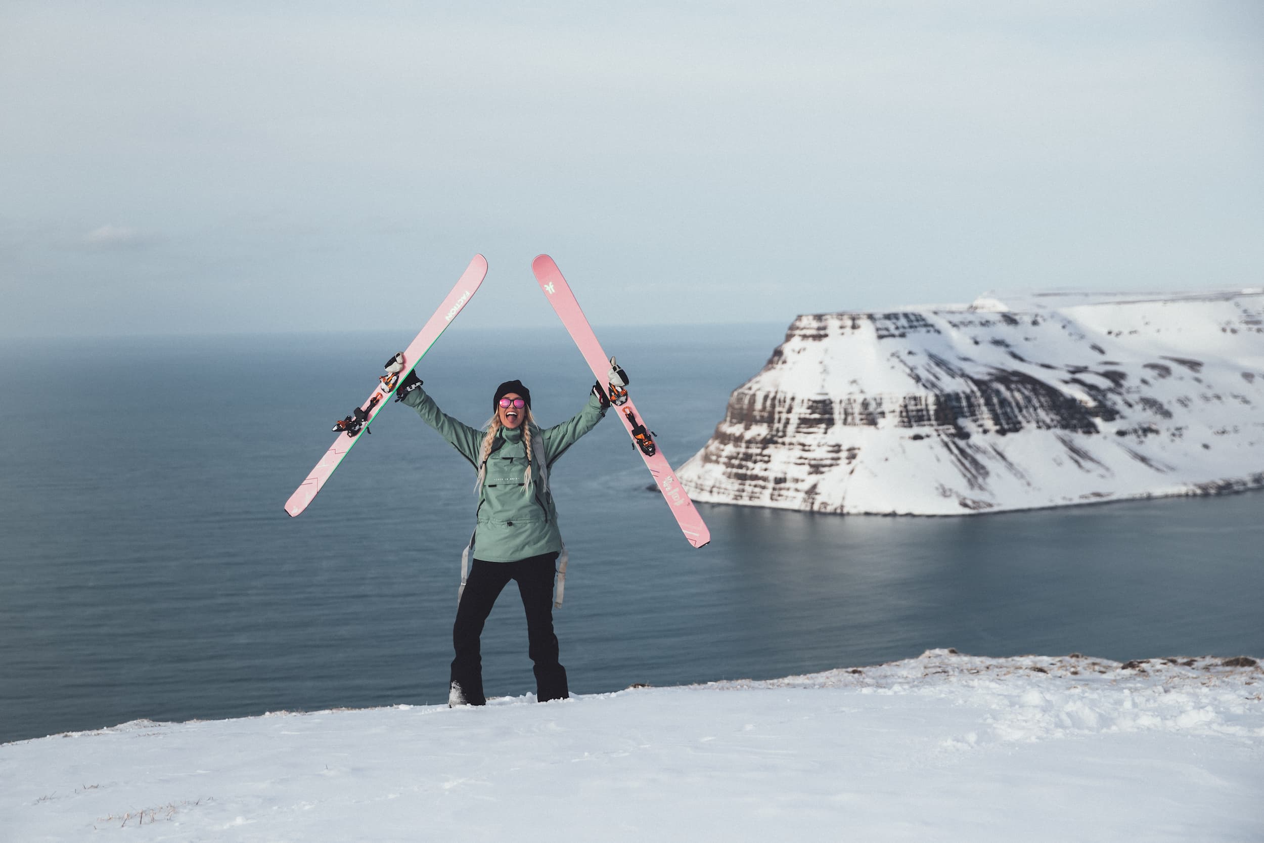 Girl in a mountain standing with her skis in her hands