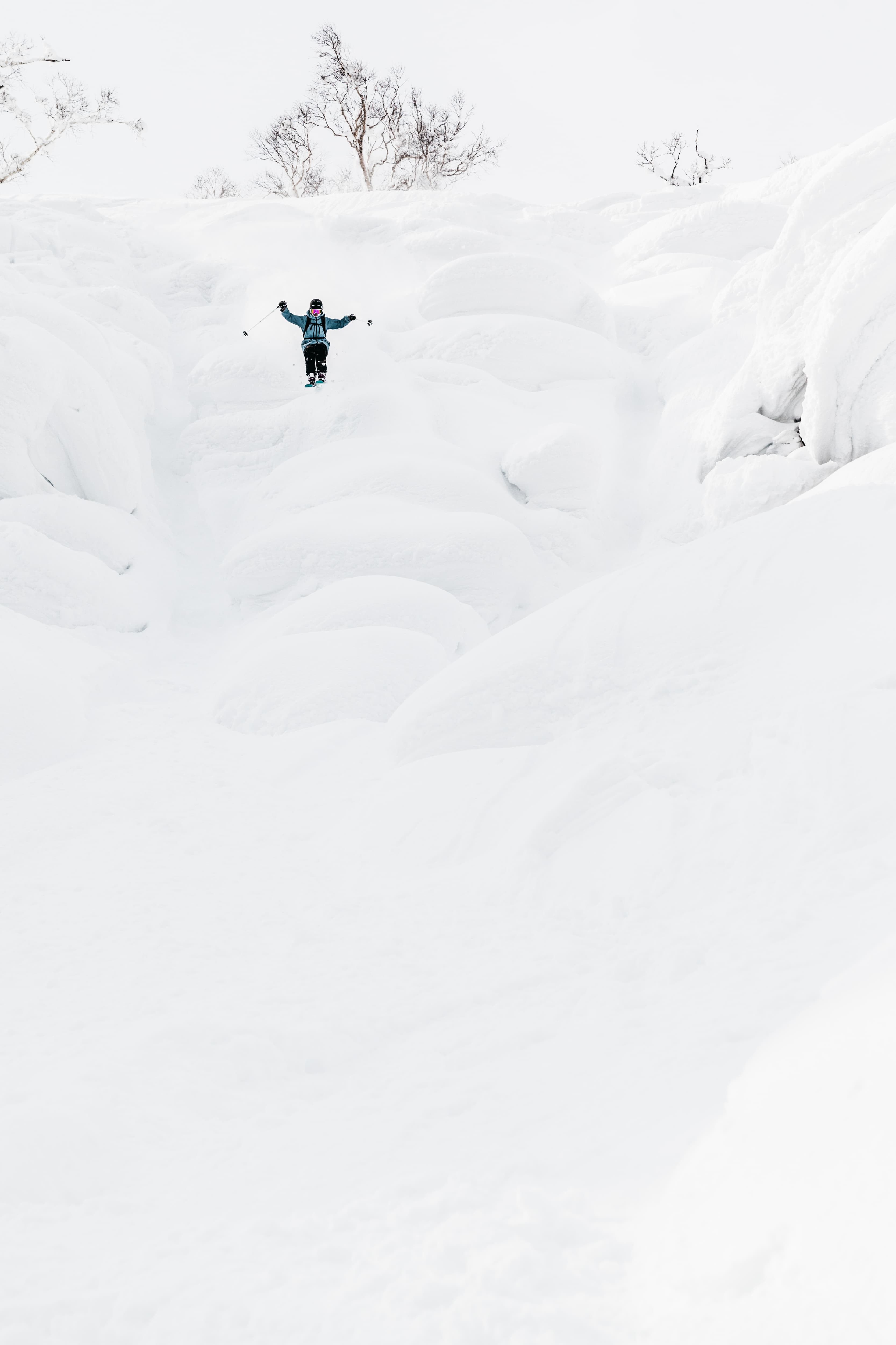Skier jumping into the fresh powder snow of Niseko