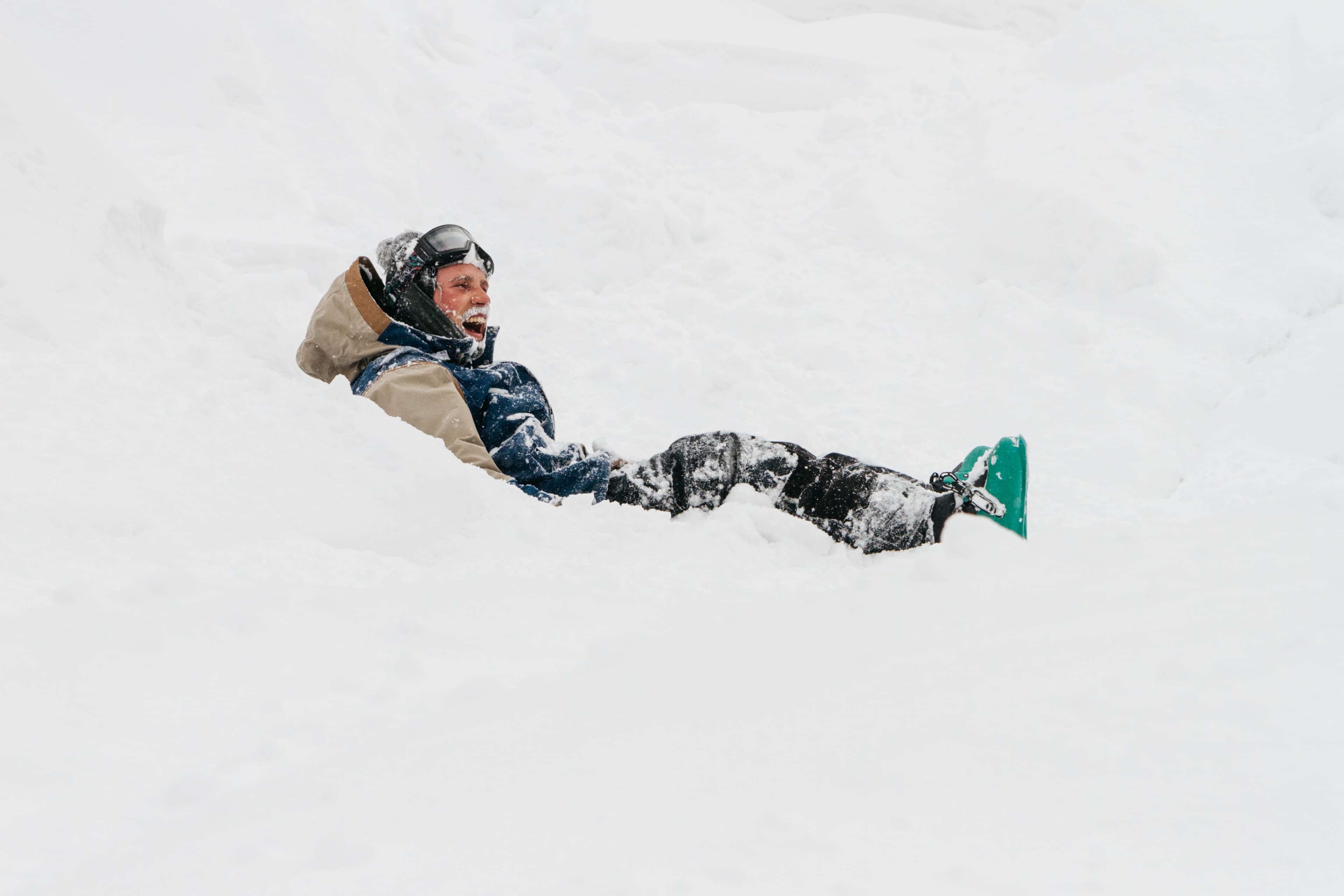 happy skier covered in snow in Niseko