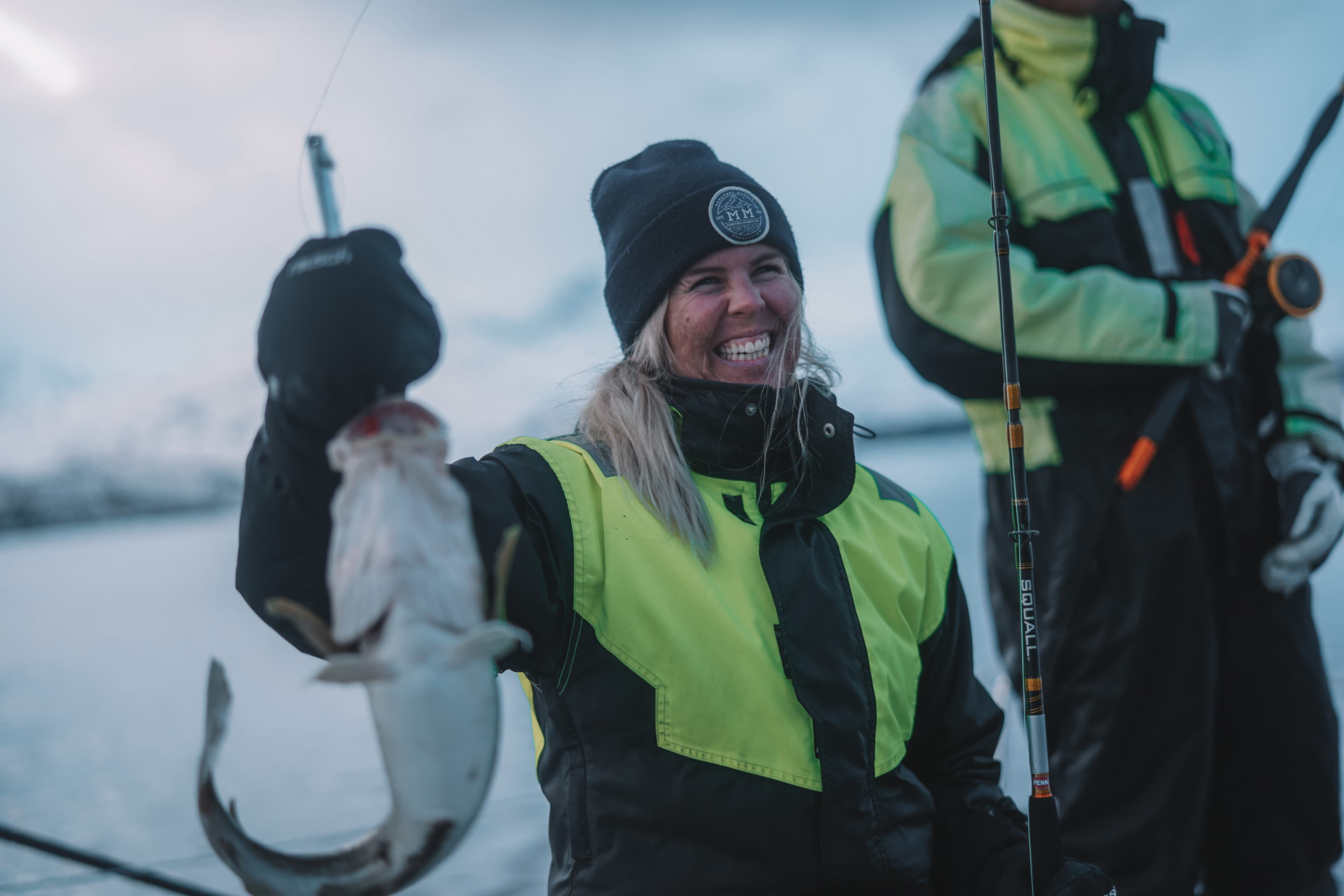 A girl holding a cod after fishing in Norway