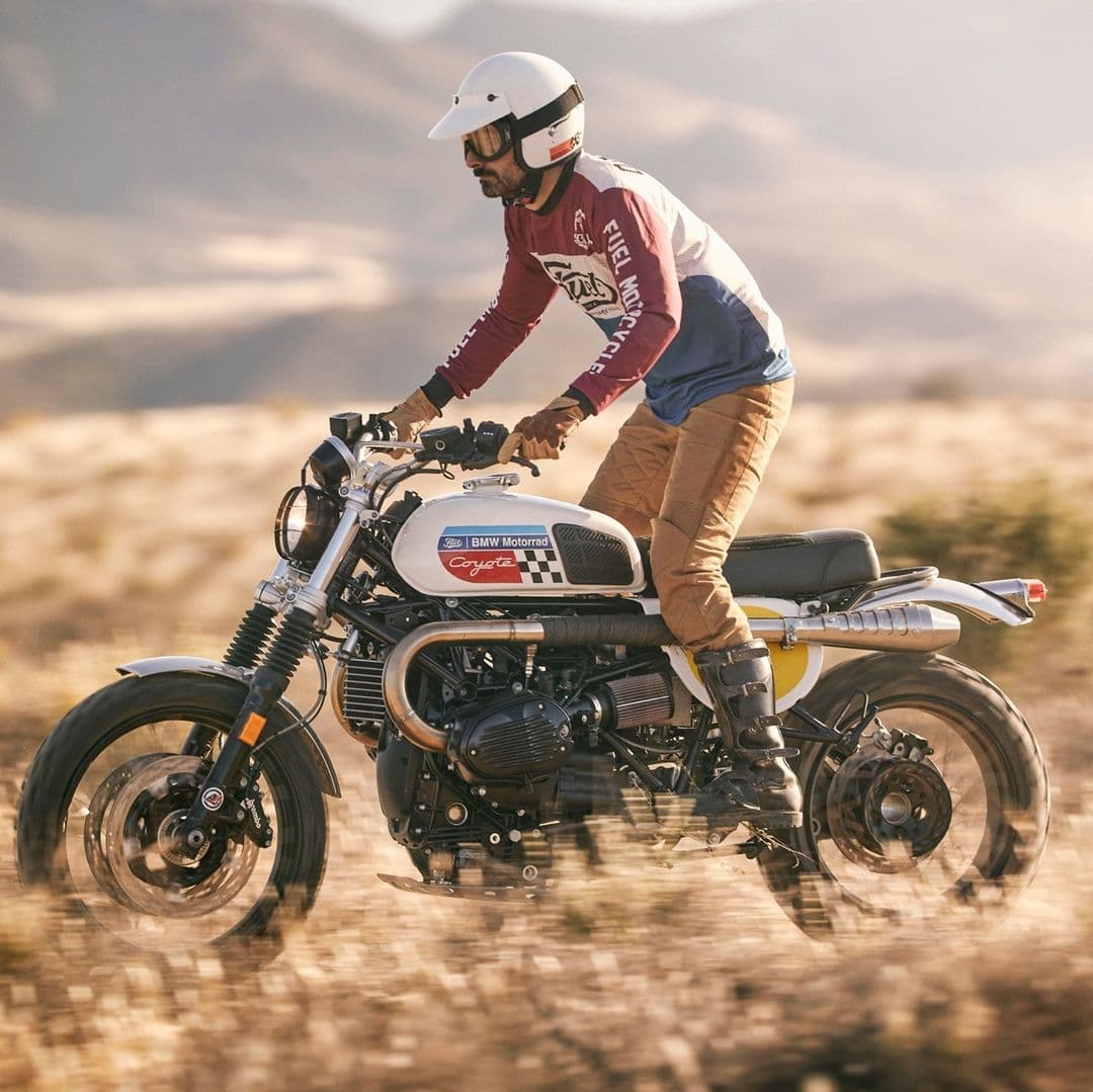 A man in the desert with Fuel motorcycles.