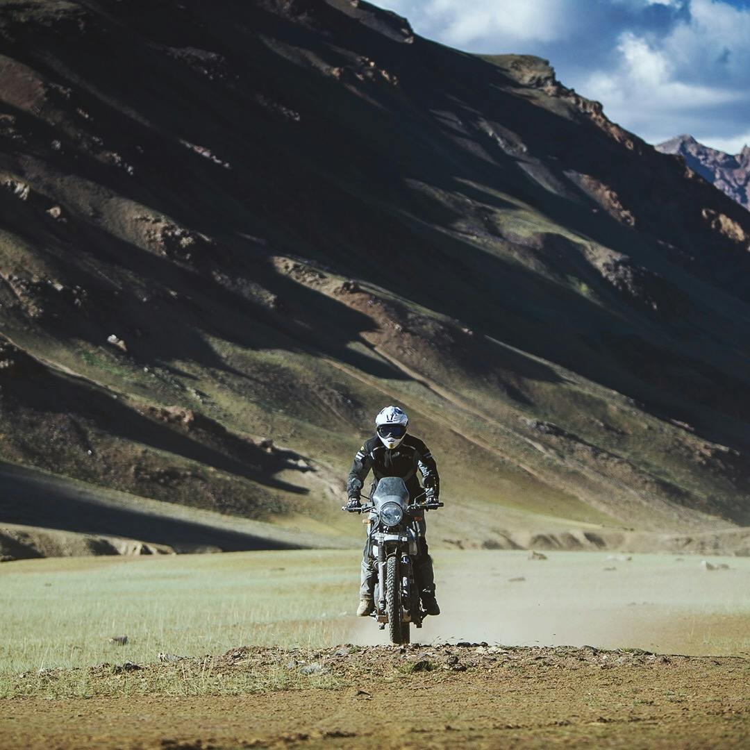 Man on Royal Enfield bike in the Himalaya