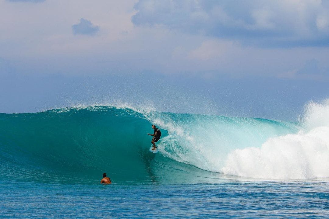 Surfer getting barreled in a wave in the Mentawais