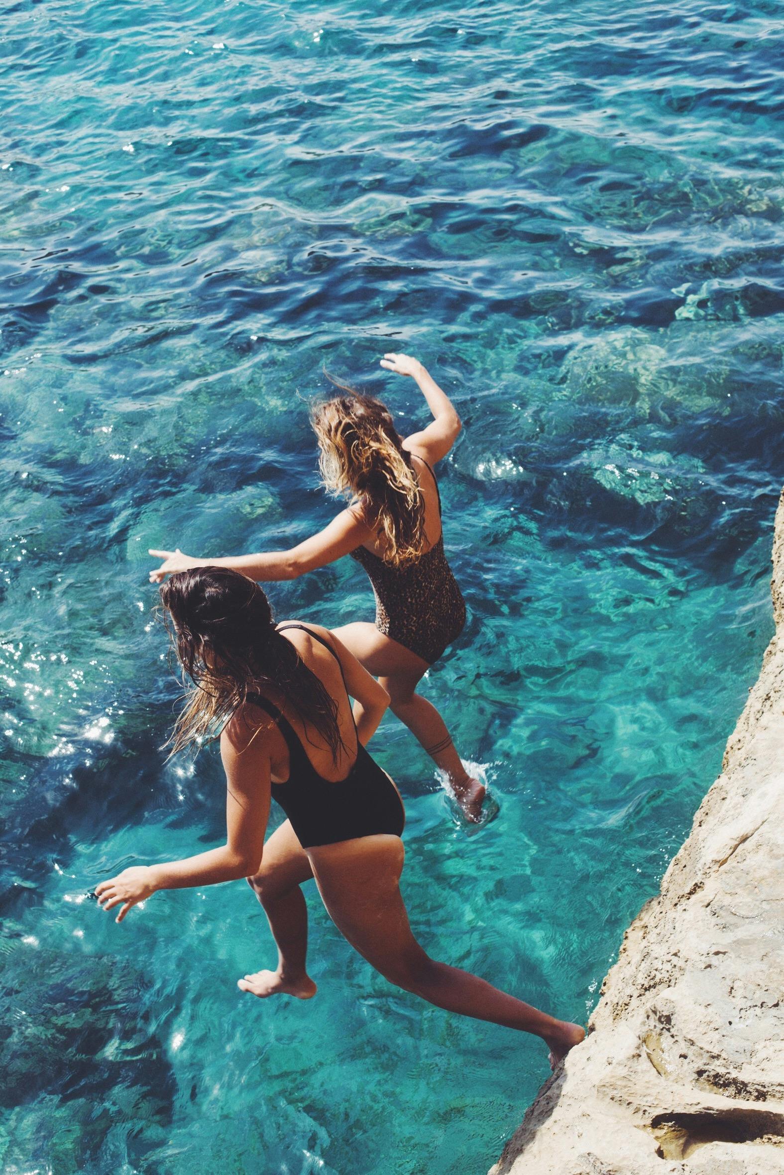 Girls jumping in the water