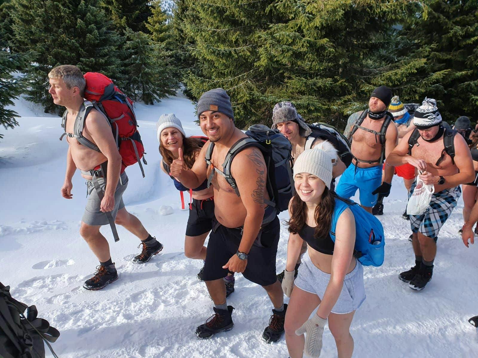 Group of Hikers in Shorts in the Snow with the Wim Hof method. 