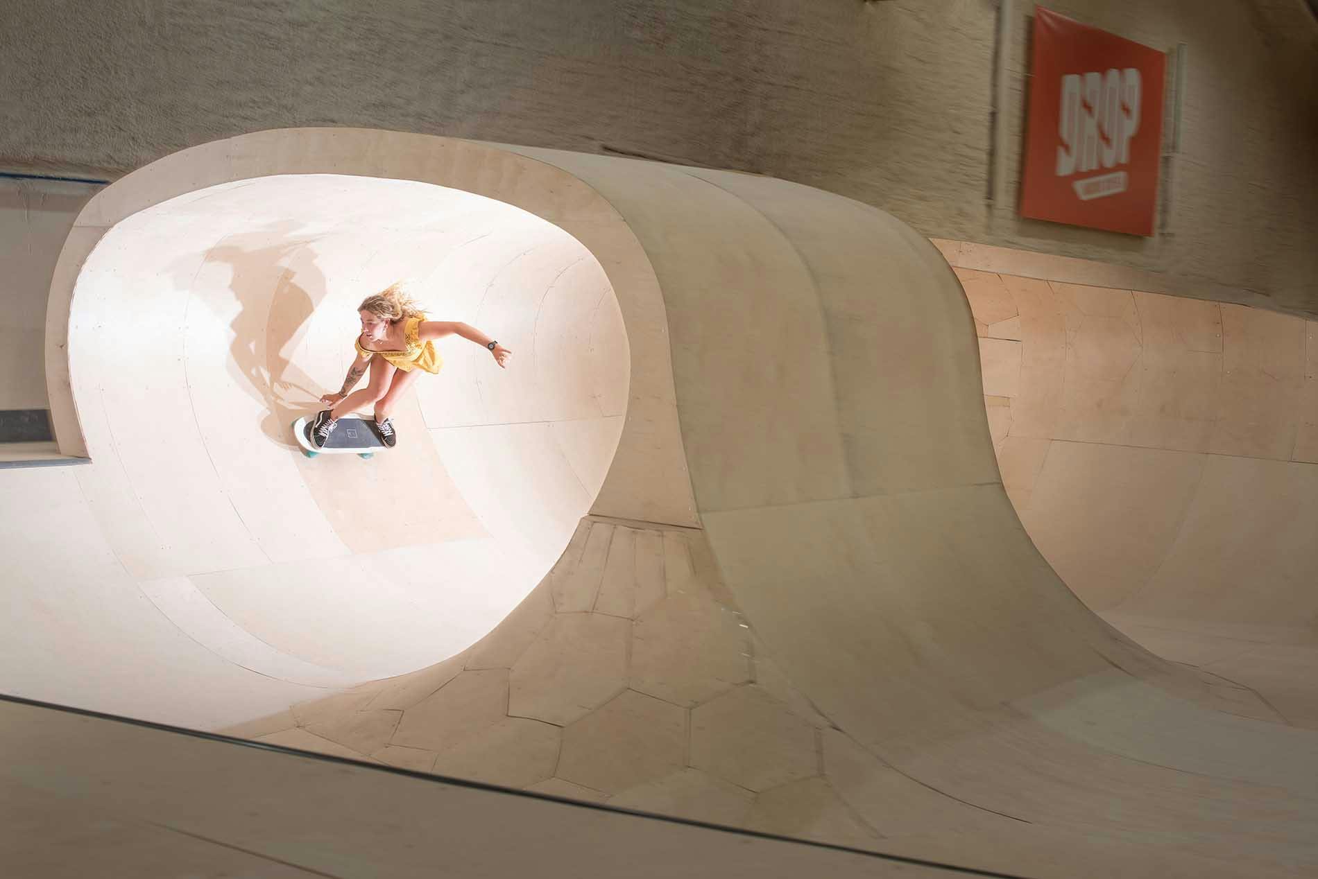 Girl Skating in an indoor Wave Skate Park