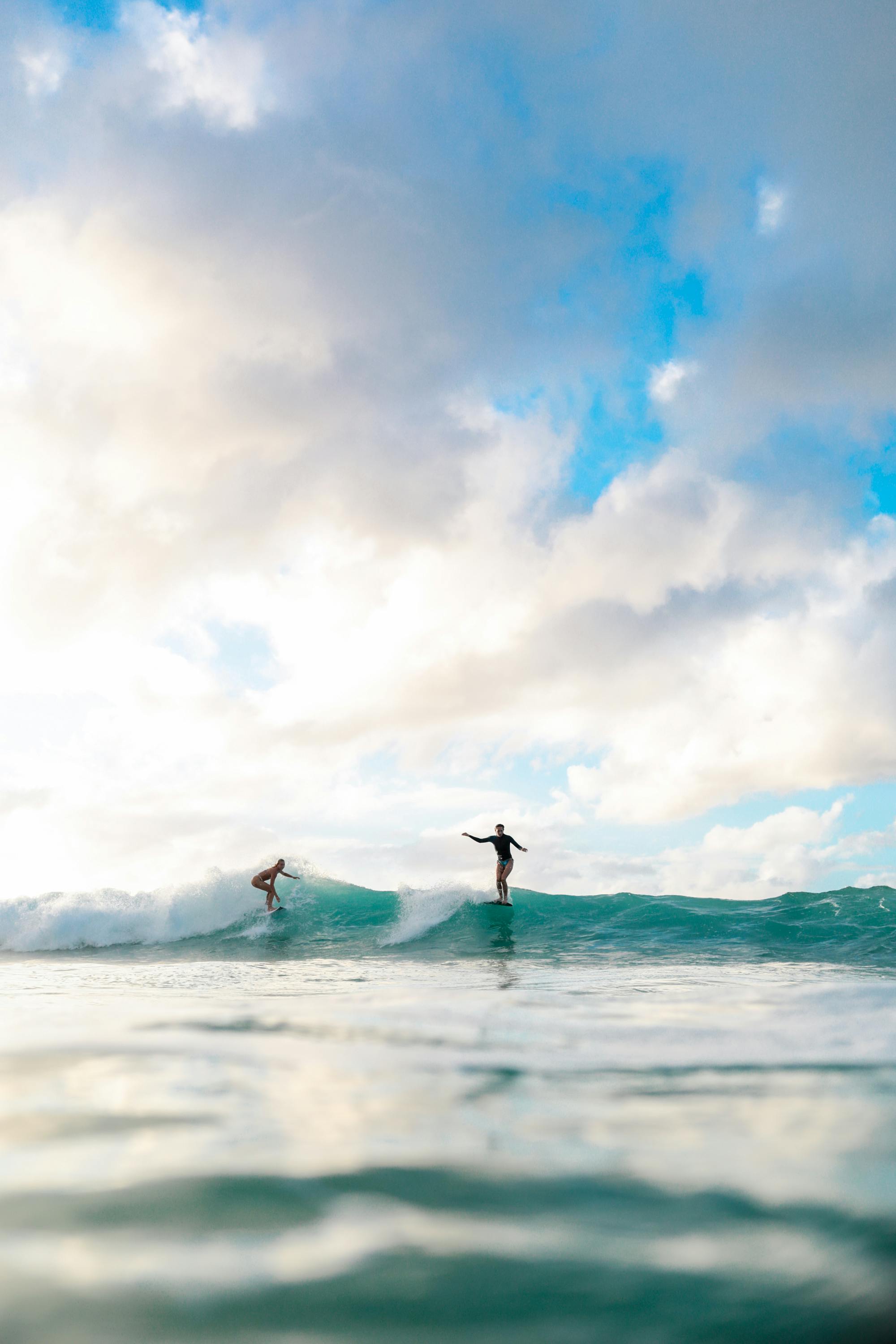 2 girls surfing in the water