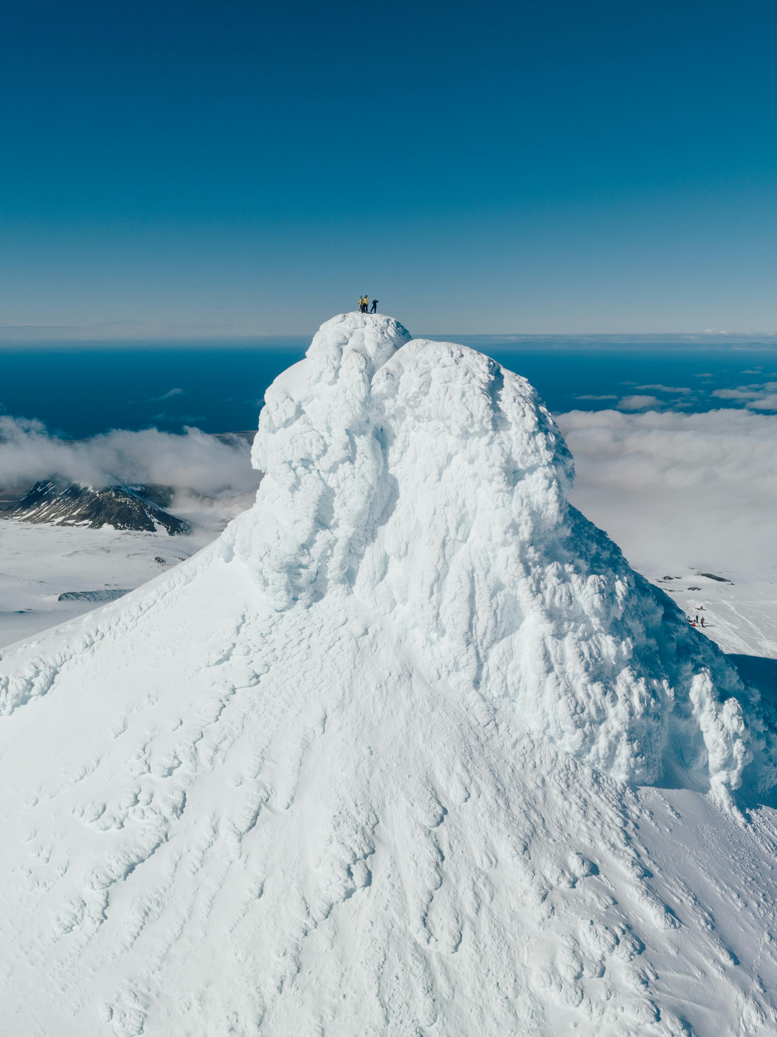 3 skiers in the top of a frozen volcano in iceland