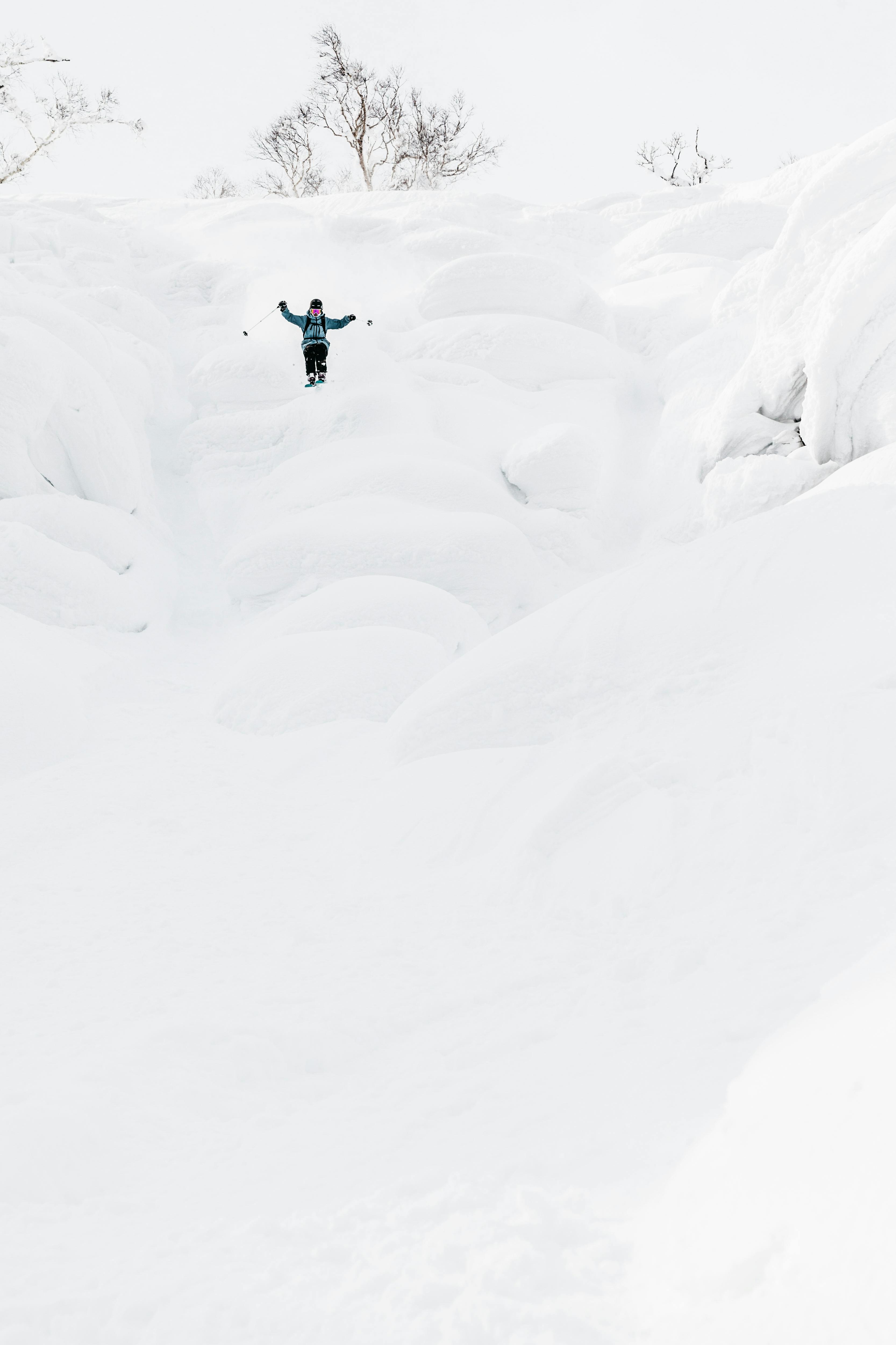 Skier jumping into the fresh powder snow of Niseko