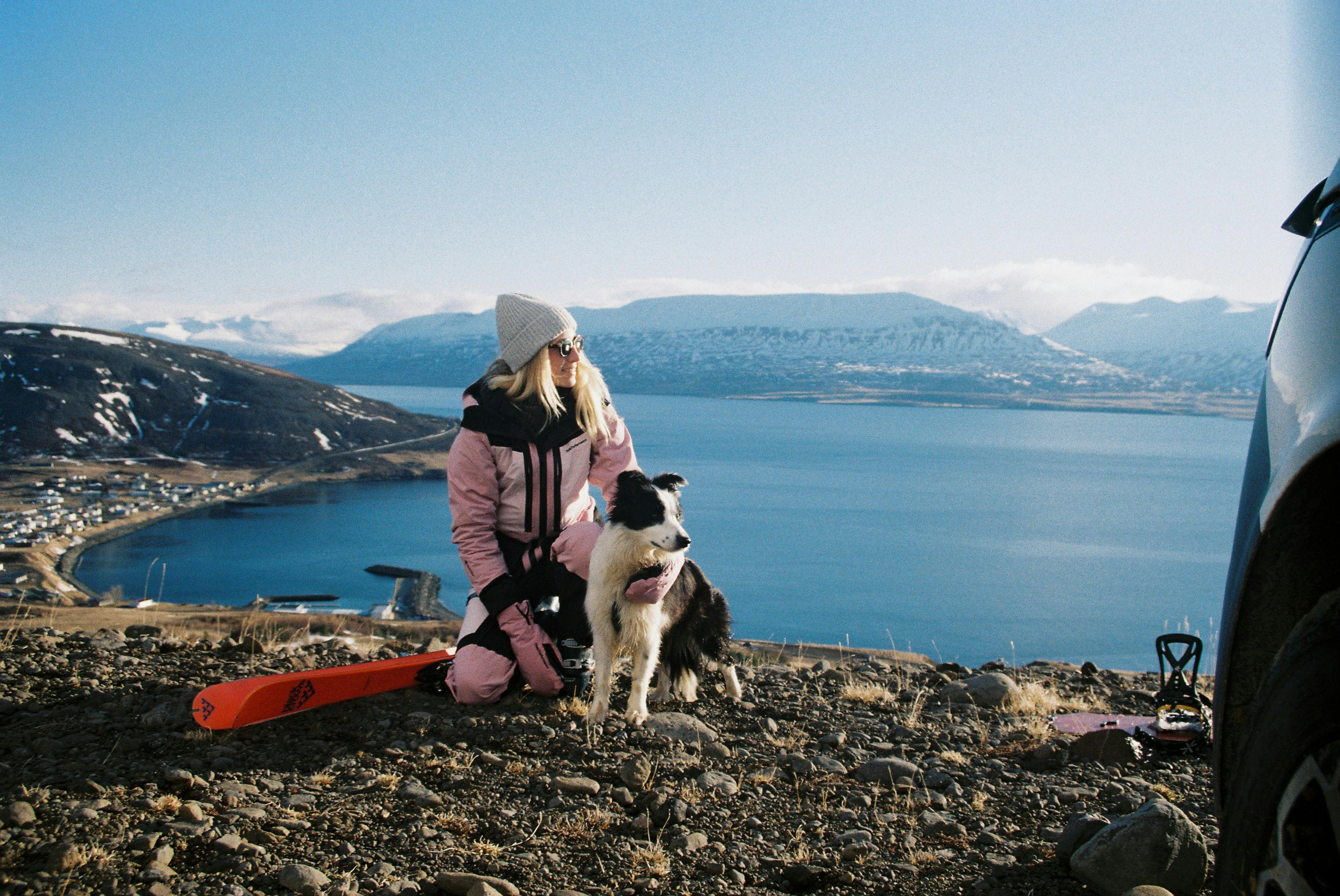 Katha with dog in Iceland in front of the ocean