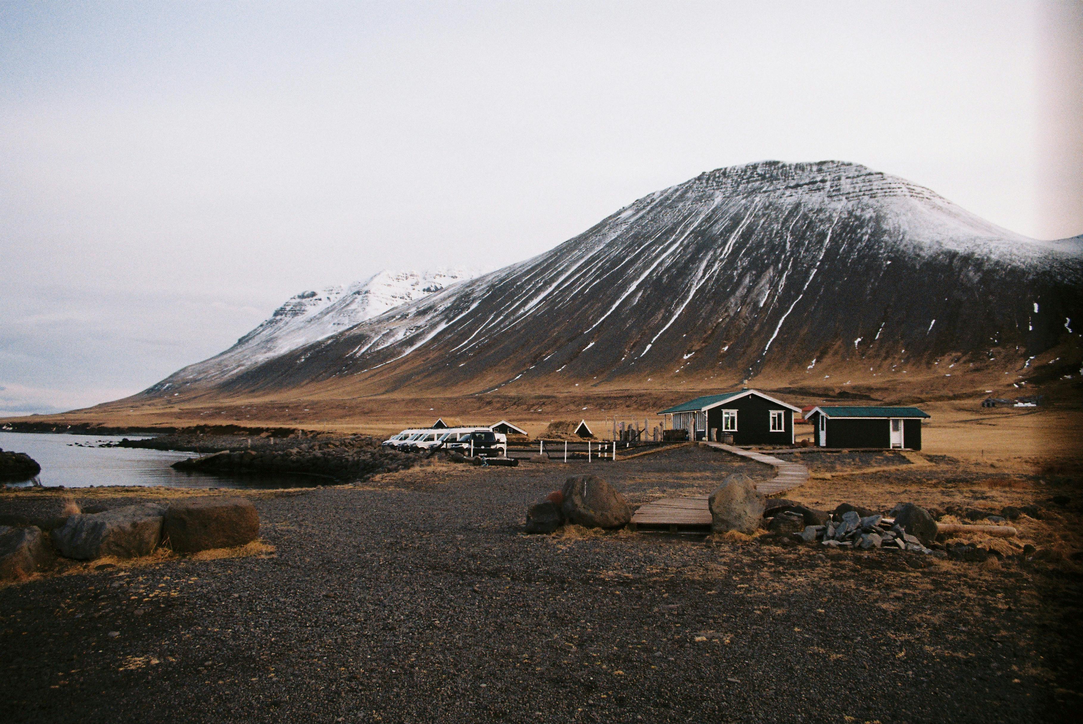 Vans parked under a mountain in Iceland