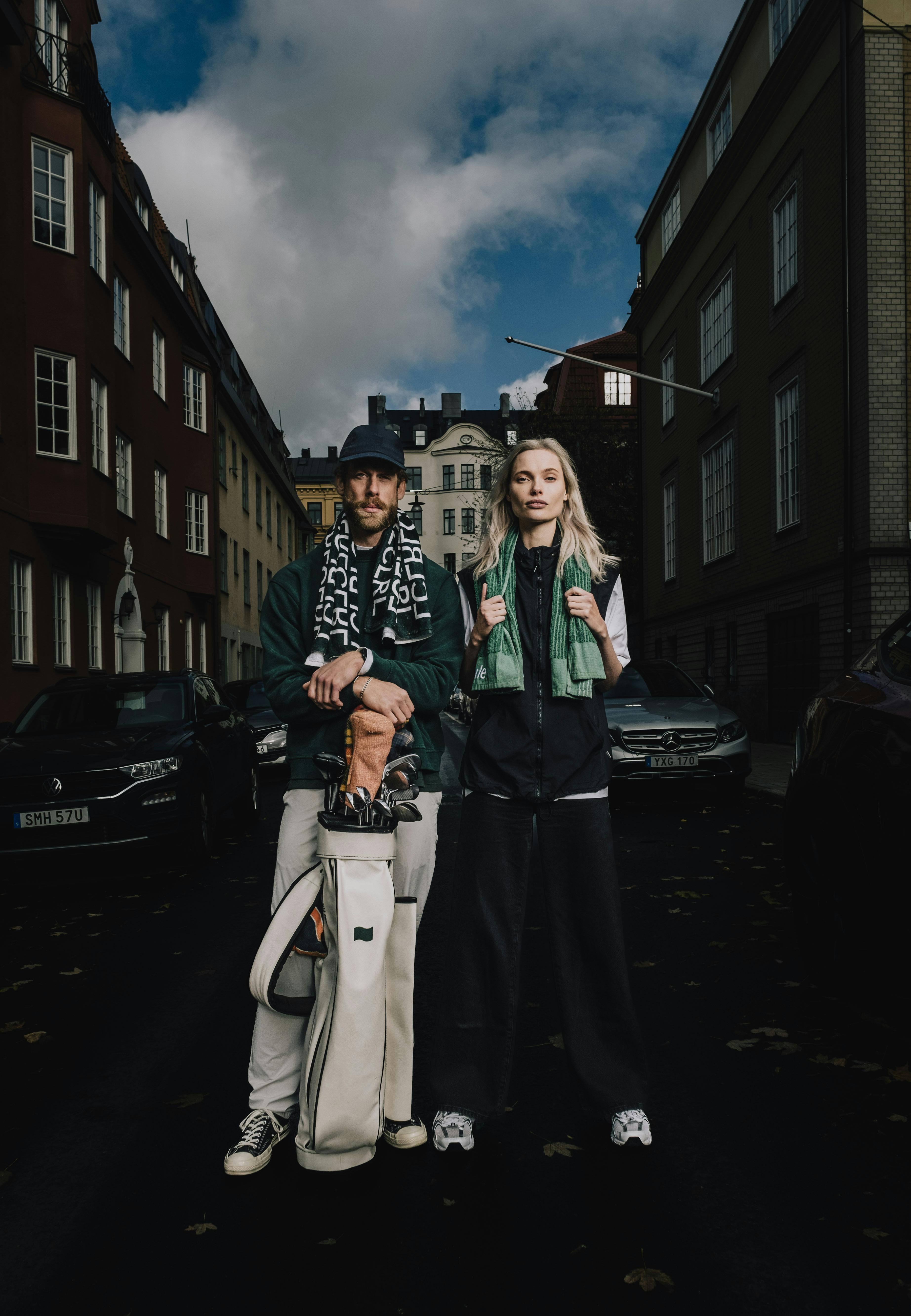 Man and woman in the streets of Stockholm wearing trendy golf attires