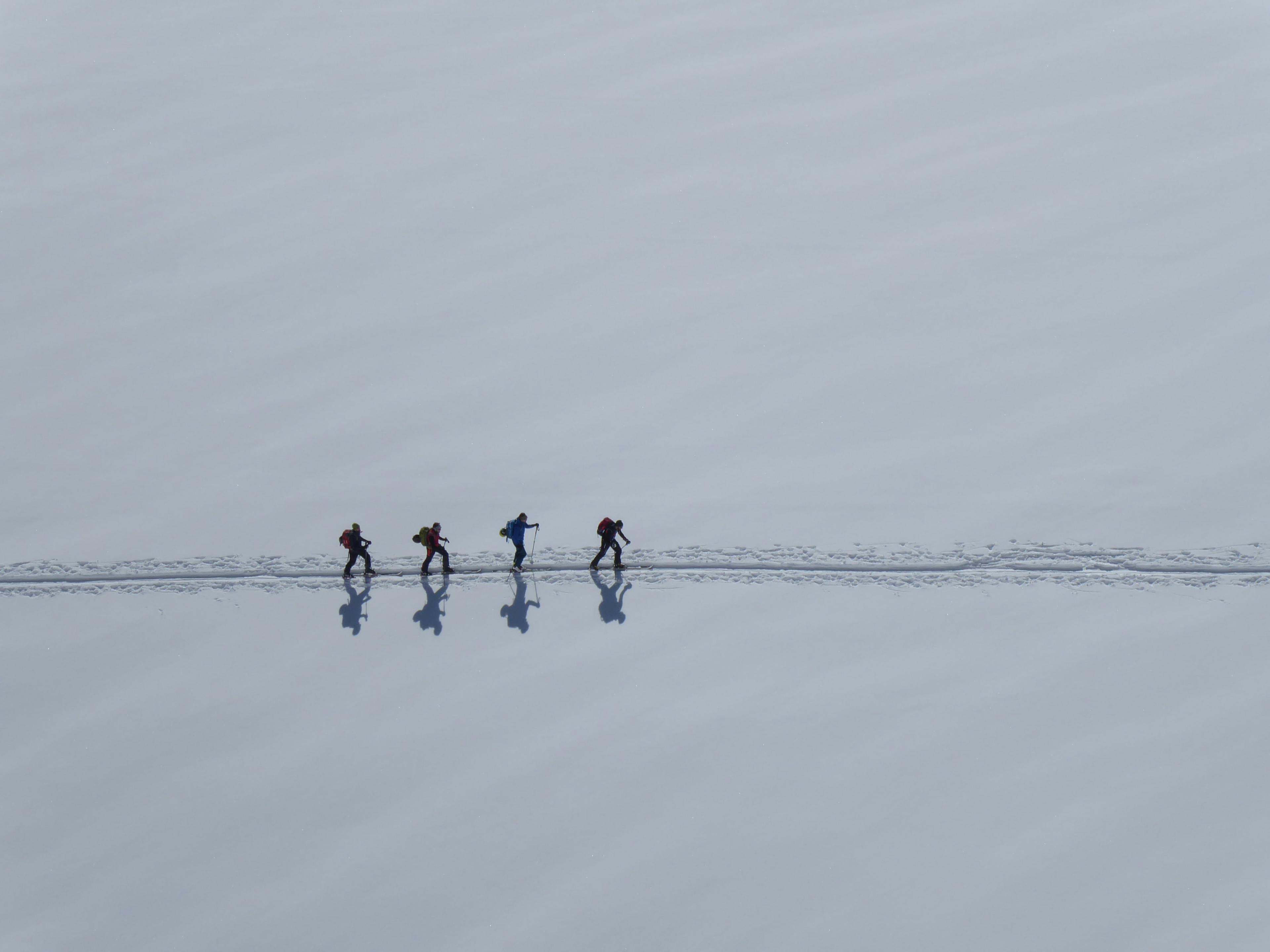 A group of 4 ski tourers from a drone