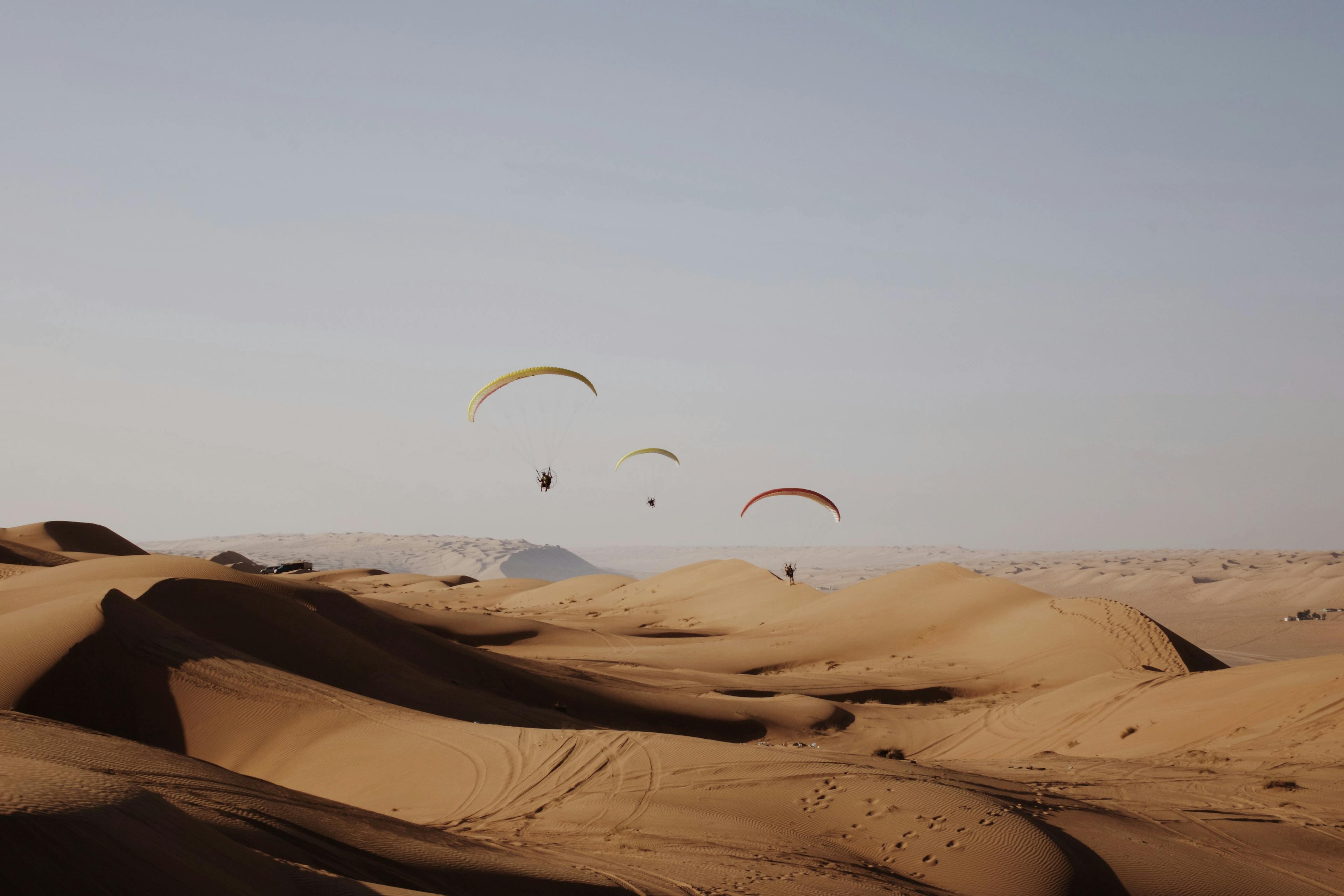 People flying with a paramotor over the desert in Namibia