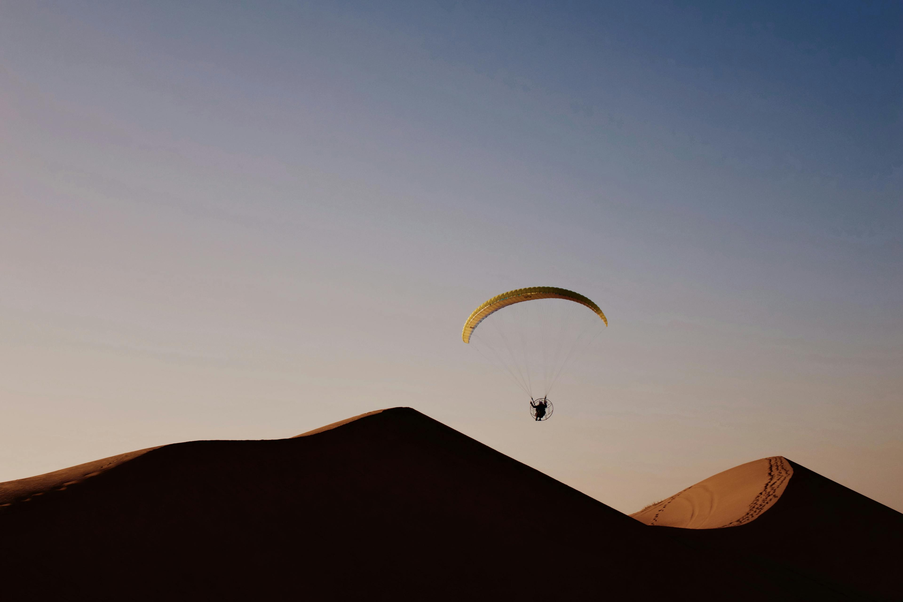 Person flying with a paramotor in the desert of Namibia