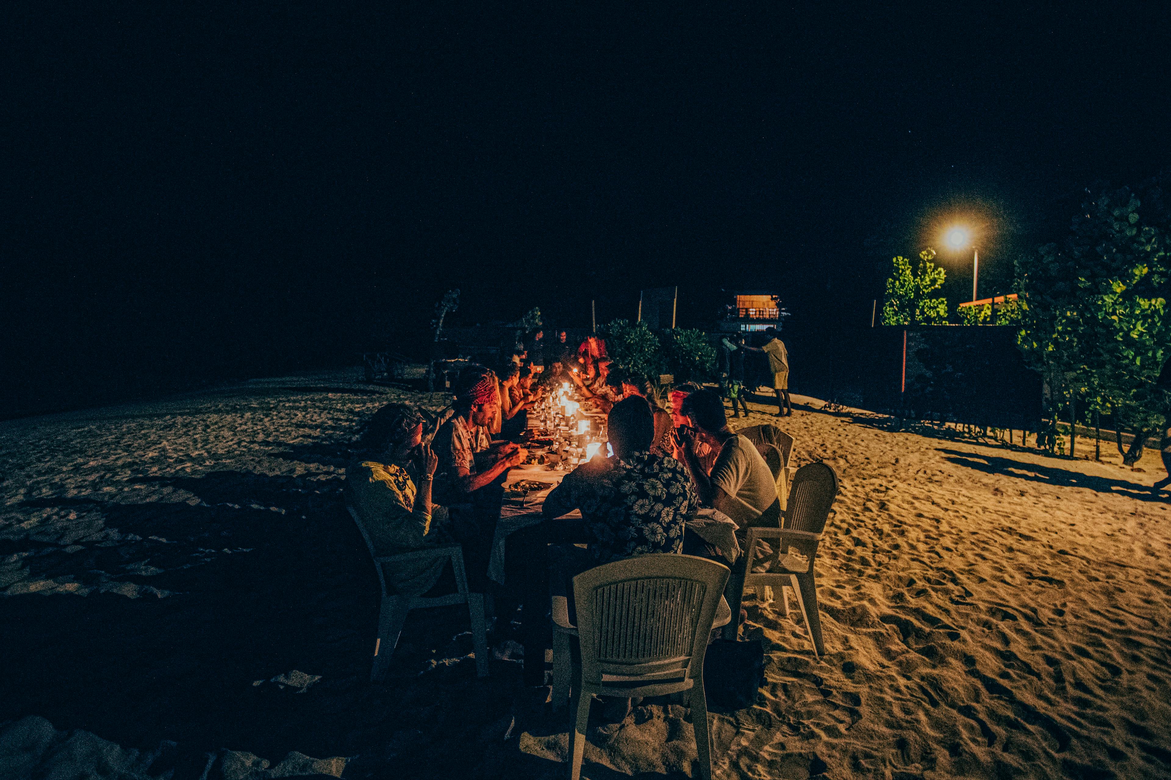 Friends having dinner at the beach in the Maldives