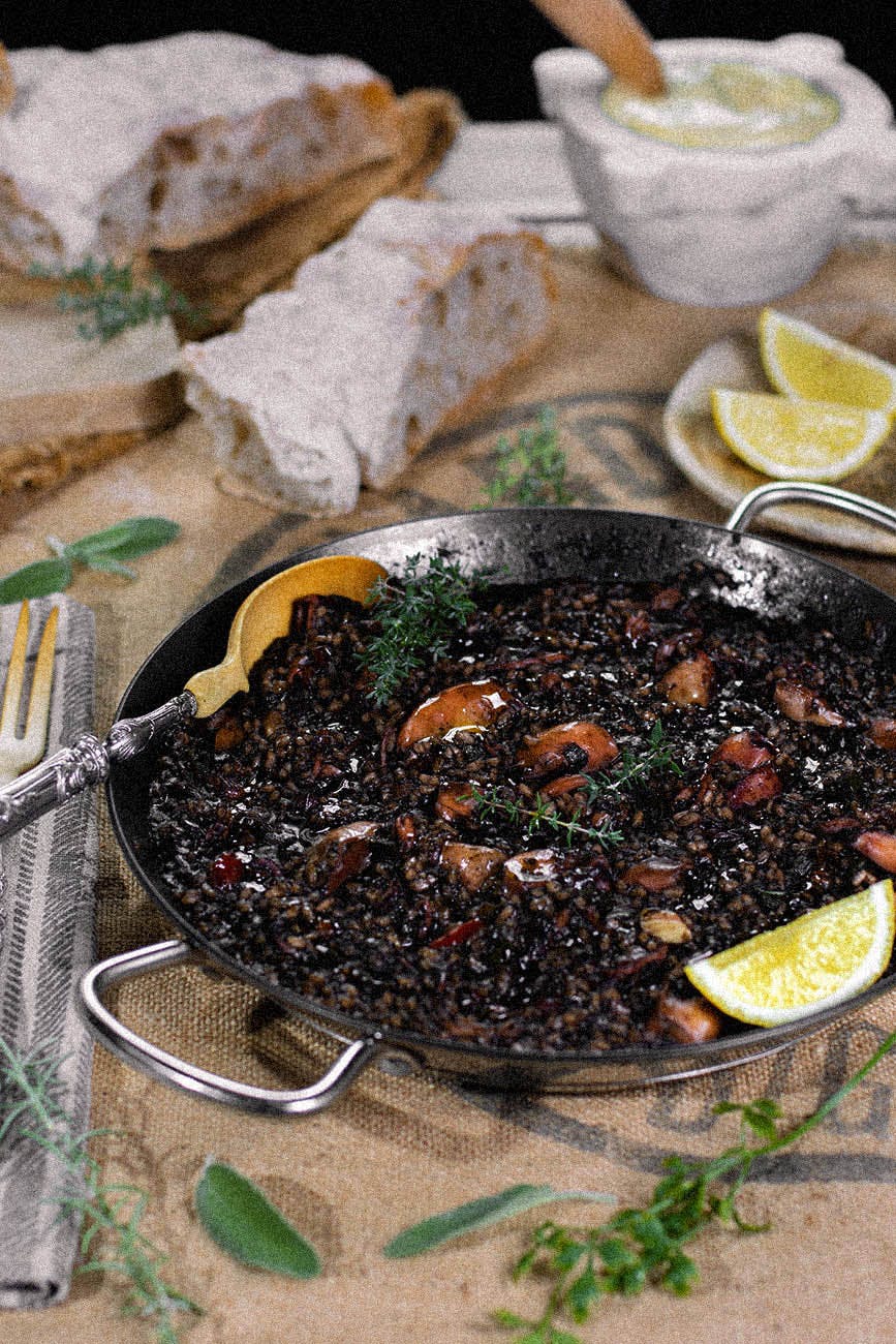 Close Up of Black Rice Paella with bread